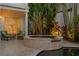 Relaxing outdoor hot tub surrounded by lush tropical landscaping and inviting patio furniture at 926 Anchorage Rd, Tampa, FL 33602