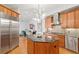 Open floor plan features wood cabinets, granite countertops, stainless appliances, and island with seating at 926 Anchorage Rd, Tampa, FL 33602