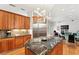 Spacious kitchen with granite island, stainless appliances, custom wood cabinetry, and open floor plan at 926 Anchorage Rd, Tampa, FL 33602
