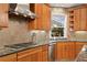 Bright kitchen features stainless steel appliances, granite counters, custom wood cabinetry, and gas range at 926 Anchorage Rd, Tampa, FL 33602