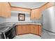 Convenient laundry room with wooden cabinetry, granite countertops, stainless steel refrigerator, and high-end washer and dryer at 926 Anchorage Rd, Tampa, FL 33602