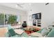 Living room with sliding doors open to patio and pool, TV, and modern furniture at 926 Anchorage Rd, Tampa, FL 33602