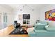 Bright living room with modern furniture, flat screen TV, and hardwood floors at 926 Anchorage Rd, Tampa, FL 33602