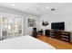 Bright main bedroom boasts wood floors, modern furniture, and a ceiling fan at 926 Anchorage Rd, Tampa, FL 33602