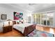 Bright main bedroom with hardwood floors, a large window, and neutral decor at 926 Anchorage Rd, Tampa, FL 33602