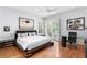 Bright main bedroom boasts wood floors, modern furniture, a ceiling fan, and natural light at 926 Anchorage Rd, Tampa, FL 33602