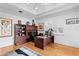 Home office with hardwood floors, a built-in bookshelf, and a large window with shutters for natural light at 926 Anchorage Rd, Tampa, FL 33602