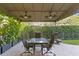 Inviting outdoor patio with a dining set and lush landscaping for privacy at 926 Anchorage Rd, Tampa, FL 33602