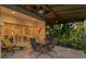 Covered patio with seating area, ceiling fans, and lush tropical landscaping at 926 Anchorage Rd, Tampa, FL 33602