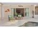 Comfortable covered patio with chairs and table overlooking pool and opening to the living room at 926 Anchorage Rd, Tampa, FL 33602