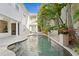This gorgeous pool has tropical foliage, a stone water feature and overlooks the two-story main house at 926 Anchorage Rd, Tampa, FL 33602