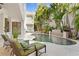 Backyard pool with lounge chairs, tropical foliage, and outdoor seating area at 926 Anchorage Rd, Tampa, FL 33602