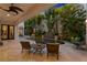 Secluded backyard with a dark bottom pool, waterfall feature and lush tropical foliage creating a private retreat at 926 Anchorage Rd, Tampa, FL 33602