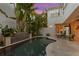 Beautiful backyard showcasing a tranquil pool, serene waterfall, and lush tropical landscaping perfect for relaxing at 926 Anchorage Rd, Tampa, FL 33602