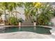 Private outdoor pool surrounded by lush tropical landscaping, offering a serene backyard retreat at 926 Anchorage Rd, Tampa, FL 33602