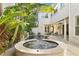 Outdoor pool and spa surrounded by lush tropical plants and an inviting backyard patio at 926 Anchorage Rd, Tampa, FL 33602