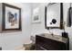 Stylish powder room features a unique glass sink, a decorative mirror, and a neutral-toned toilet at 926 Anchorage Rd, Tampa, FL 33602