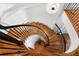 Elegant wooden spiral staircase with wrought iron railings, offering a unique architectural detail at 926 Anchorage Rd, Tampa, FL 33602