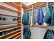 Spacious walk-in closet is equipped with custom wood shelving and rods for optimal organization and storage at 926 Anchorage Rd, Tampa, FL 33602