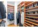 Organized walk-in closet features custom built-in wood shelving and hanging racks for clothes and accessories at 926 Anchorage Rd, Tampa, FL 33602
