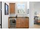 Bedroom wet bar featuring granite countertops, wood cabinetry, mini fridge, and views of the bed at 926 Anchorage Rd, Tampa, FL 33602