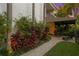 Landscaped backyard featuring a stone path leading to a covered patio area at 926 Anchorage Rd, Tampa, FL 33602