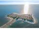 Aerial view of Fred Howard Park beach and causeway bathed in sunlight against a blue sky and tranquil ocean backdrop at 1020 Lake Avoca Dr, Tarpon Springs, FL 34689