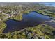 This aerial view showcases the neighborhood's waterfront homes and serene lake access to the bay at 1020 Lake Avoca Dr, Tarpon Springs, FL 34689