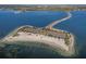 Overhead view of Fred Howard Park, showcasing sandy beaches, lush greenery, parking, and access to the ocean at 1020 Lake Avoca Dr, Tarpon Springs, FL 34689