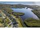 This aerial view showcases the neighborhood's waterfront homes and serene lake access to the bay at 1020 Lake Avoca Dr, Tarpon Springs, FL 34689