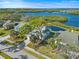 Residential street view featuring well-maintained homes, mature trees, and scenic water views at 1020 Lake Avoca Dr, Tarpon Springs, FL 34689
