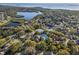 Residential community featuring a community pool, tennis courts and water views at 1020 Lake Avoca Dr, Tarpon Springs, FL 34689