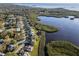 This aerial view showcases the neighborhood's waterfront homes and serene lake access to the bay at 1020 Lake Avoca Dr, Tarpon Springs, FL 34689