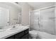 Well-lit bathroom featuring a modern vanity and a shower with sliding glass doors at 1020 Lake Avoca Dr, Tarpon Springs, FL 34689