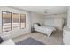 Cozy bedroom with a ceiling fan, plush carpet, and a serene view from the window at 1020 Lake Avoca Dr, Tarpon Springs, FL 34689