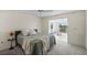 Cozy bedroom with natural light leads to outdoor seating area with a view at 1020 Lake Avoca Dr, Tarpon Springs, FL 34689