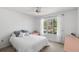 Bright bedroom with a ceiling fan and large window providing natural light at 1020 Lake Avoca Dr, Tarpon Springs, FL 34689