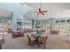 Spacious clubhouse featuring multiple seating areas, ceiling fans, high ceilings, and large windows offering ample natural light at 1020 Lake Avoca Dr, Tarpon Springs, FL 34689
