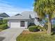 Charming single-Gathering home featuring a two-car garage and inviting entryway at 1020 Lake Avoca Dr, Tarpon Springs, FL 34689