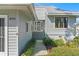 Charming home entrance with well-kept landscaping and an inviting front door at 1020 Lake Avoca Dr, Tarpon Springs, FL 34689