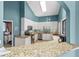 Well-lit kitchen with granite countertops, stainless steel appliances, white cabinets, and a breakfast bar at 1020 Lake Avoca Dr, Tarpon Springs, FL 34689