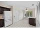 Kitchen featuring white appliances, tile flooring, and ample natural light at 1020 Lake Avoca Dr, Tarpon Springs, FL 34689