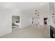 Open concept living room with fireplace and tile floors, connecting to the kitchen and a bedroom at 1020 Lake Avoca Dr, Tarpon Springs, FL 34689