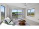 Inviting sunroom with large windows offering a view of the lake and natural surroundings at 1020 Lake Avoca Dr, Tarpon Springs, FL 34689