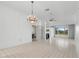 Spacious living room with tile floors, fireplace, and natural light from large windows at 1020 Lake Avoca Dr, Tarpon Springs, FL 34689