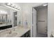 Main bathroom featuring a vanity with storage, a toilet, and a large mirror at 1020 Lake Avoca Dr, Tarpon Springs, FL 34689