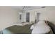 Bright main bedroom featuring a ceiling fan, walk-in closet, and ensuite bath at 1020 Lake Avoca Dr, Tarpon Springs, FL 34689
