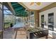 Covered patio area with ping pong and foosball tables and views of the community pool, ideal for outdoor activities at 1020 Lake Avoca Dr, Tarpon Springs, FL 34689