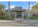 The recreation center features a welcoming entrance with columns, planters, and manicured landscaping at 1020 Lake Avoca Dr, Tarpon Springs, FL 34689