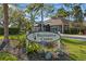 Community Recreation Center entrance sign surrounded by lush landscaping with palm trees and shrubbery at 1020 Lake Avoca Dr, Tarpon Springs, FL 34689